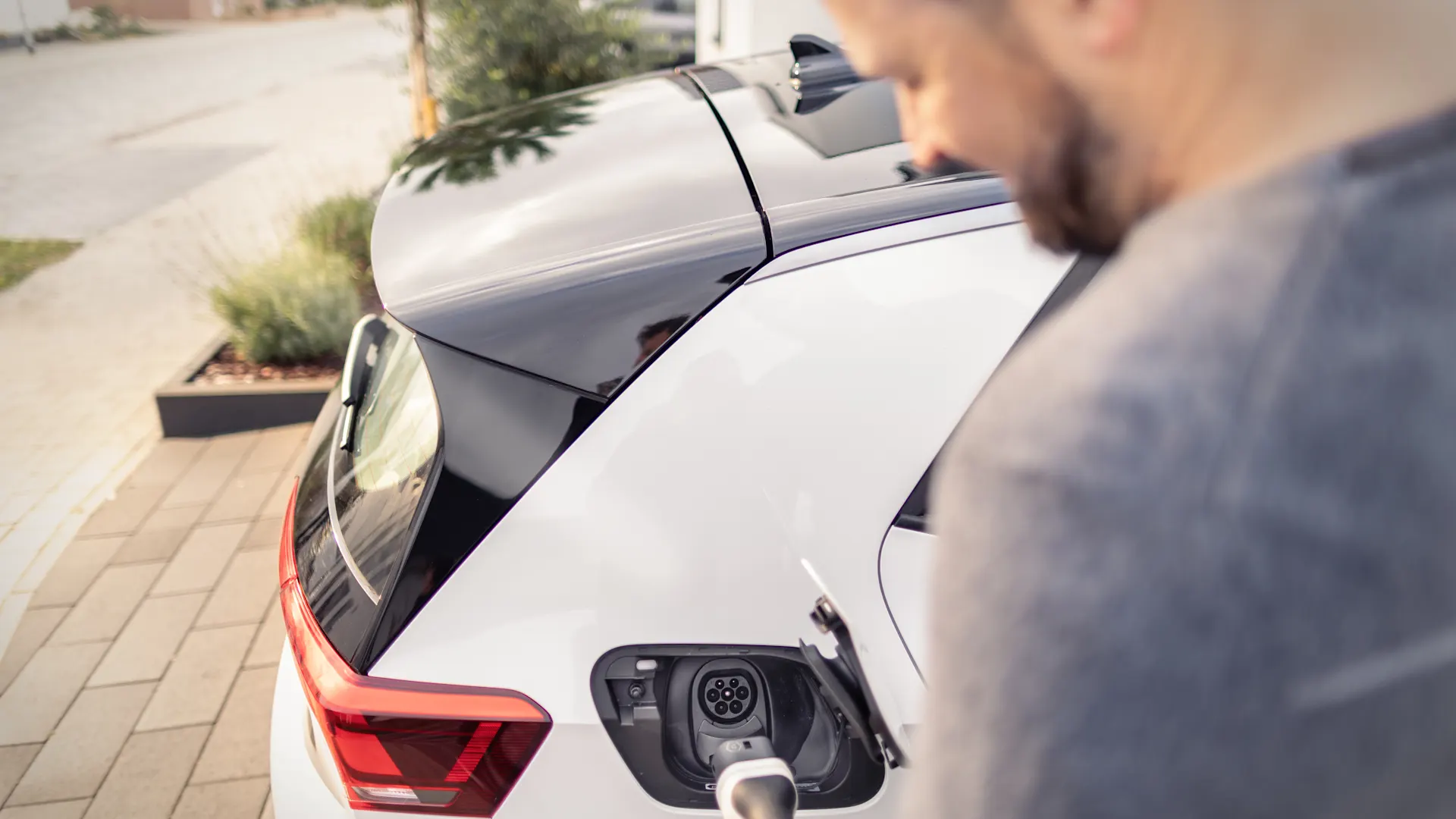 Ein Mann nutzt seine installierte Wallbox Ein Mann lädt sein Elektroauto mit seiner installierten Wallbox.