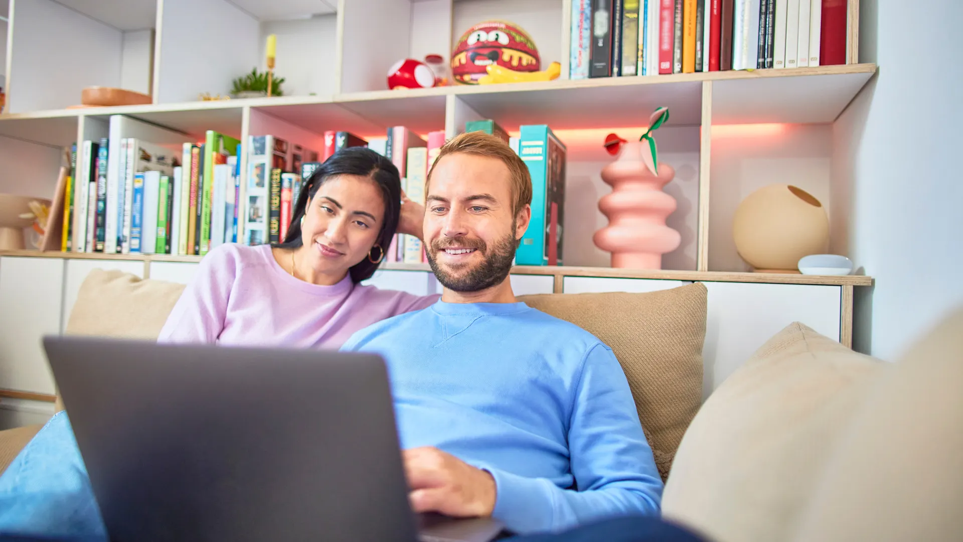 Ein Paar sitzt am Laptop und besucht die NEW Netz Website Ein Paar sitzt im Wohnzimmer an ihrem Laptop und besucht die NEW Netz Website