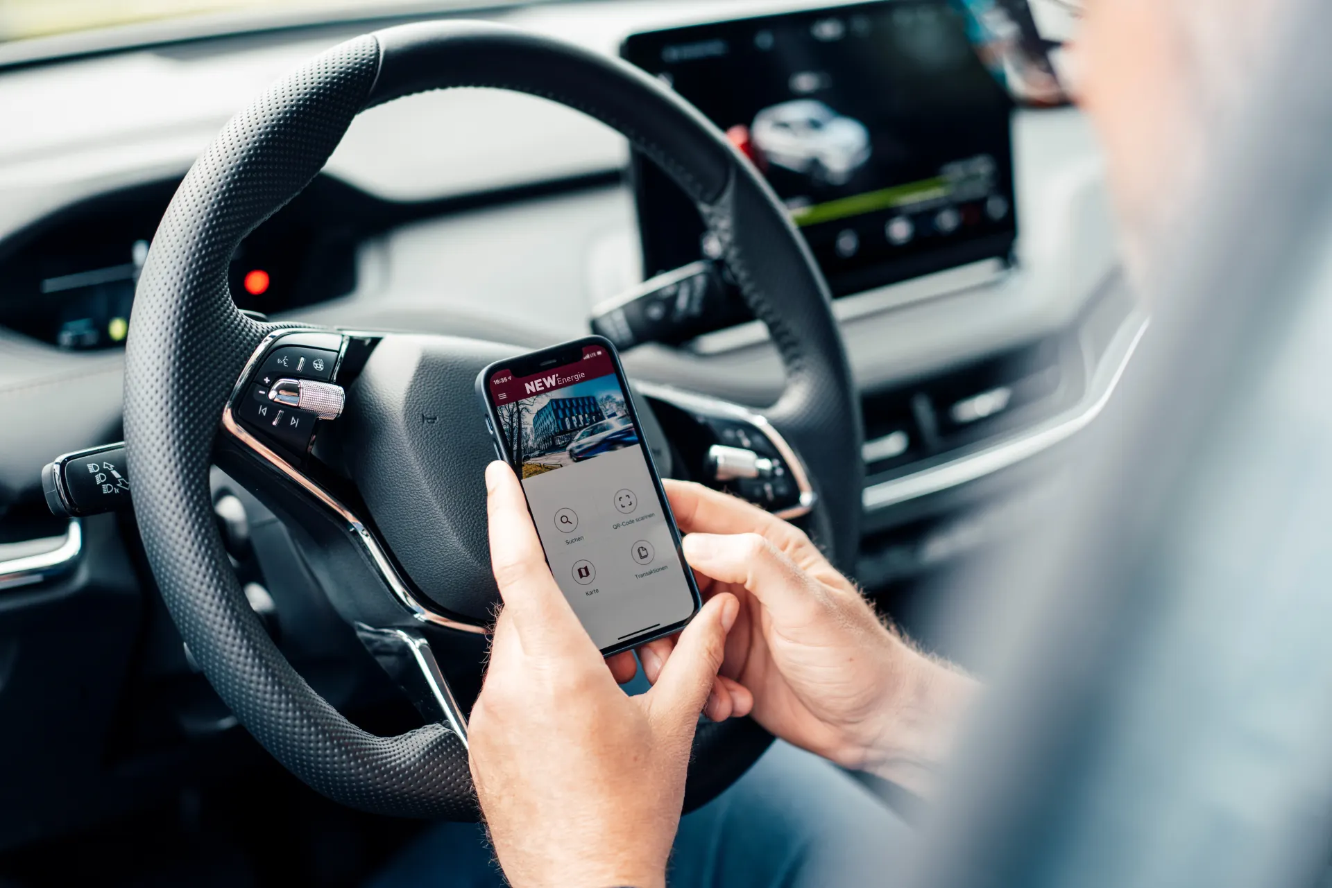 Der Mann kann über sein Smartphone mit einer App alles fürs E-Auto steuern und einsehen.