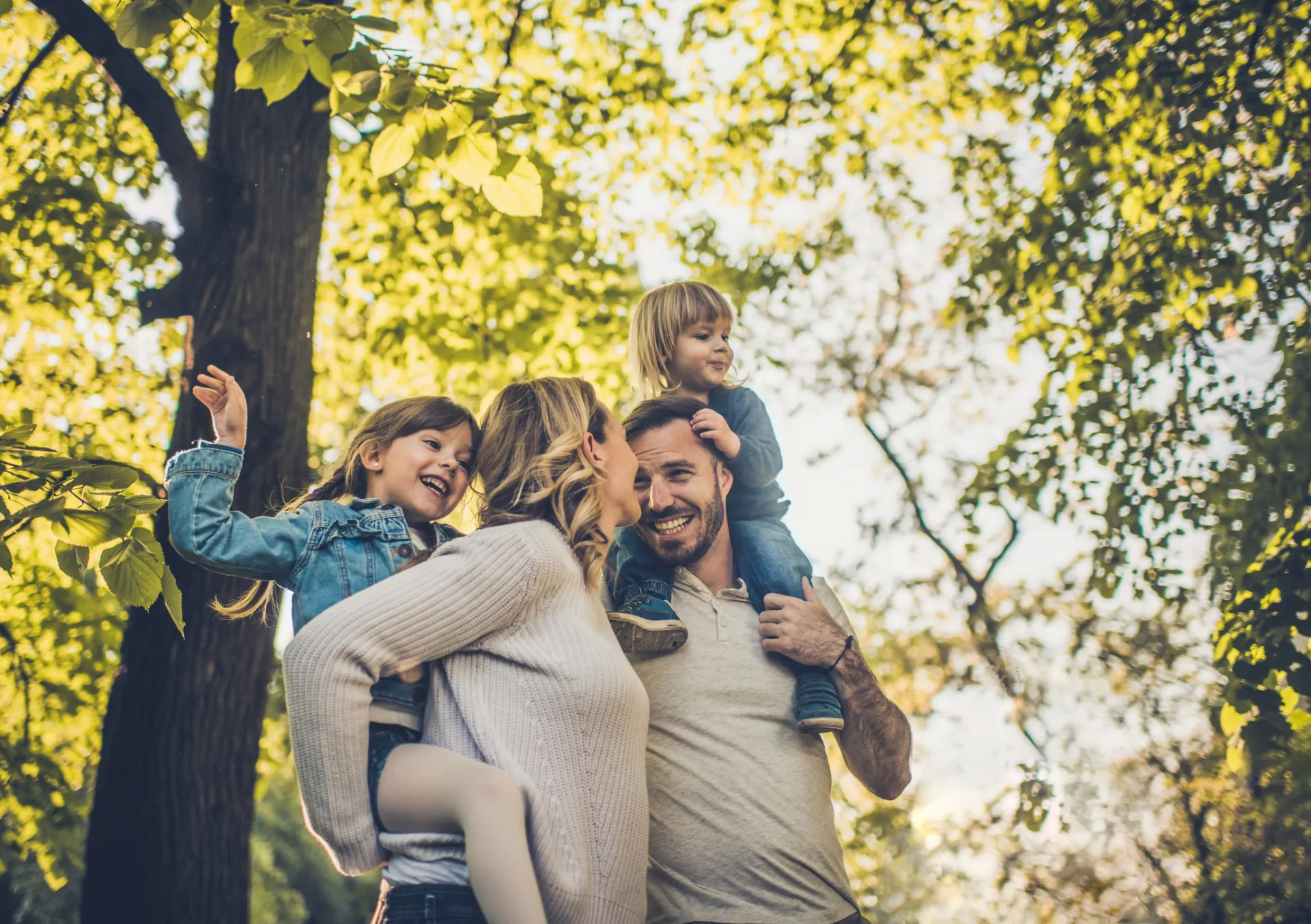 Eine Familie mit zwei Kindern ist sehr naturverbunden und befindet sich im Wald. Sie nutzen Ökostrom der NEW Energie.