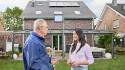 Beratung Photovoltaikanlage Ein NEW Mitarbeiter berät eine Kundin vor ihrem Einfamilienhaus bezüglich einer Photovoltaikanlage von der NEW Energie und grüner Energie.