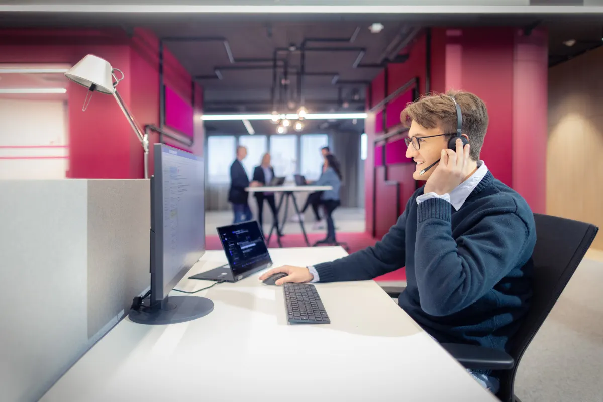 Mann mit Headset im Open Space Büro