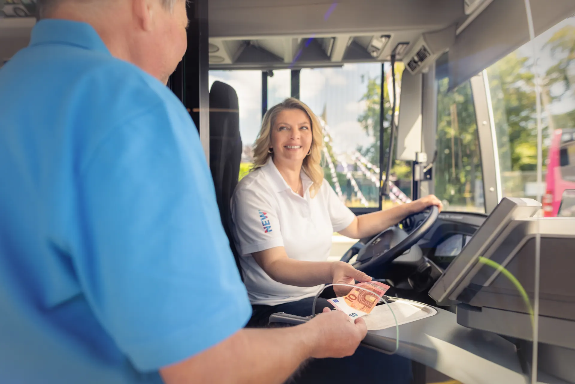 Fahrgast kauft Ticket direkt im Bus bei der Busfahrerin.